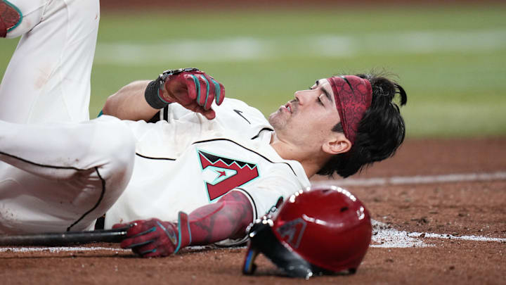 Arizona Diamondbacks batter Corbin Carroll (7) falls to the ground after avoiding a wild pitch against the Los Angeles Dodgers at Chase Field in Phoenix, on Sept. 24, 2025. Arizona Diamondbacks batter Corbin Carroll (7) falls to the ground after avoiding a wild pitch against the Los Angeles Dodgers at Chase Field in Phoenix, on Sept. 24, 2025.