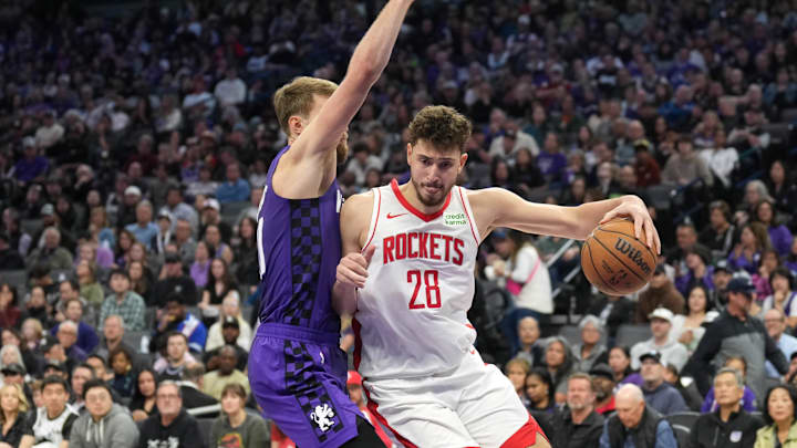 Mar 10, 2024; Sacramento, California, USA; Houston Rockets center Alperen Sengun (28) dribbles against Sacramento Kings forward Domantas Sabonis (left) during the third quarter at Golden 1 Center. Mandatory Credit: Darren Yamashita-USA TODAY Sports