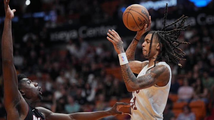 Mar 24, 2024; Miami, Florida, USA;  Cleveland Cavaliers forward Emoni Bates (21) looks to pass the ball as Miami Heat center Thomas Bryant (31) defends during the second half at Kaseya Center. Mandatory Credit: Jim Rassol-Imagn Images