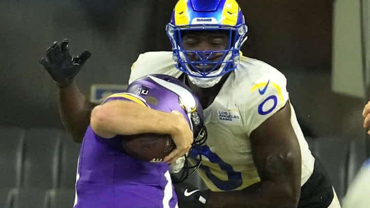 Oct 24, 2024; Inglewood, California, USA; Los Angeles Rams linebacker Byron Young (0) tackles Minnesota Vikings quarterback Sam Darnold (14) for a safety in the second half at SoFi Stadium.