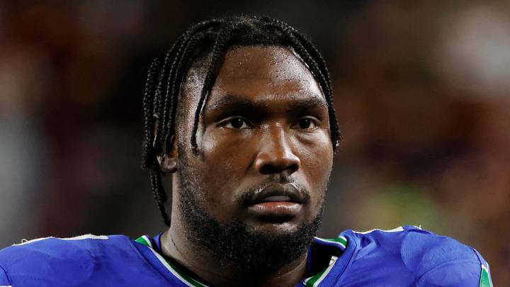 Seattle Seahawks offensive tackle Charles Cross looks on