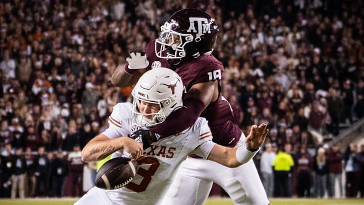 Texas Longhorns quarterback Quinn Ewers (3) is sacked by Texas A&M Aggies defensive lineman Cashius Howell (18) in the third quarter of the Lone Star Showdown at Kyle Field.