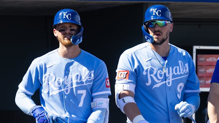 Feb 25, 2026; Surprise, Arizona, USA; Kansas City Royals shortstop Bobby Witt Jr. (left) and first baseman Vinnie Pasquantino against the Seattle Mariners during a spring training game at Surprise Stadium. Mandatory Credit: Mark J. Rebilas-Imagn Images