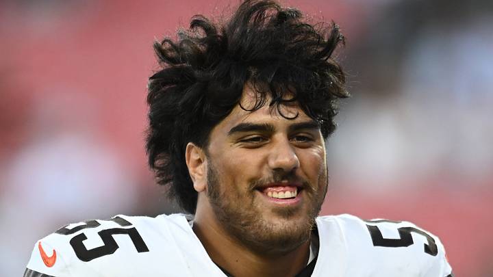 Cleveland Browns tackle Spencer Fano (55) smiles