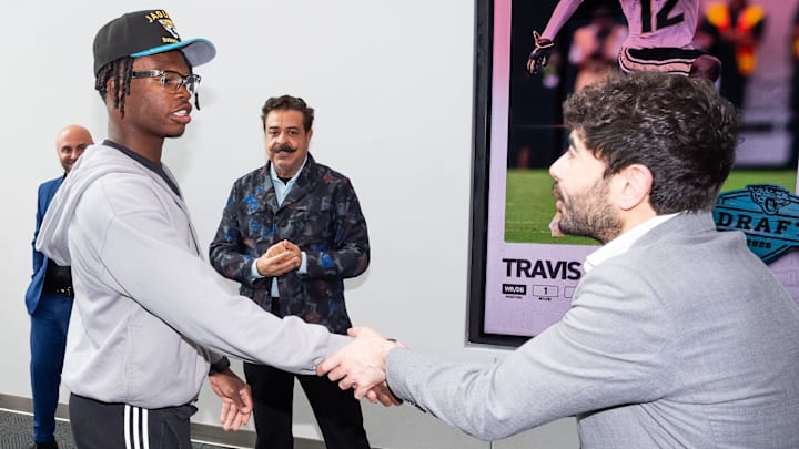 The Jacksonville Jaguars first-round pick, Colorado Buffaloes wide receiver and defensive back Travis Hunter, left, was greeted by Jaguars owner Shahid Khan, center, and his son Tony Khan, right, after Hunter arrived on Friday, March 25, 2025 at Miller Electric Center in Jacksonville, Fla. The team traded up from fifth to second after making a deal with the Cleveland Browns on Thursday night. [Doug Engle/Florida Times-Union]