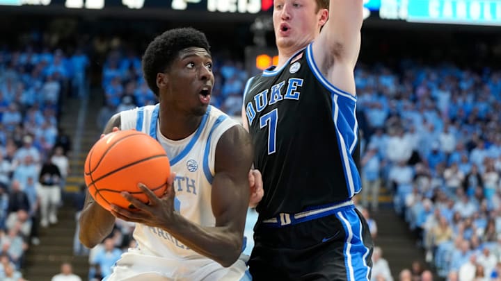 Mar 8, 2025; Chapel Hill, North Carolina, USA;  North Carolina Tar Heels guard Drake Powell (9) with the ball as Duke Blue Devils guard Kon Knueppel (7) defends in the second half at Dean E. Smith Center. Mandatory Credit: Bob Donnan-Imagn Images