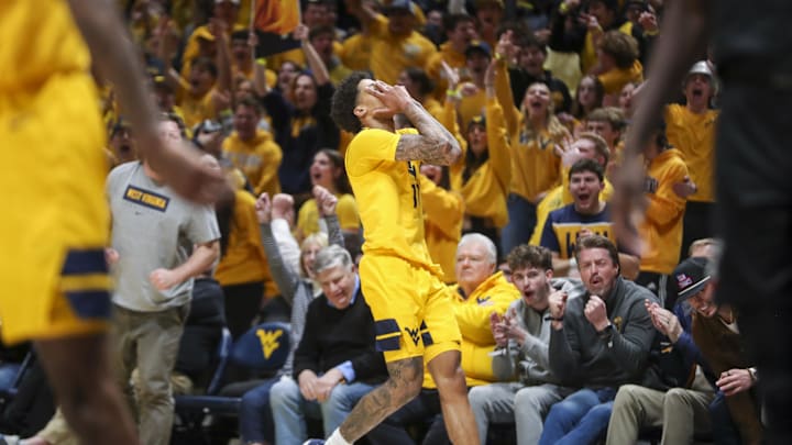 Feb 19, 2025; Morgantown, West Virginia, USA; West Virginia Mountaineers guard Jonathan Powell (11) celebrates after a made three point shot during the second half against the Cincinnati Bearcats at WVU Coliseum. Mandatory Credit: Ben Queen-Imagn Images