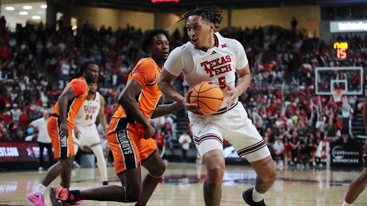Jan 26, 2025; Lubbock, Texas, USA;  Texas Tech Red Raiders forward Darrion Williams (5) grabs a rebound in front of Oklahoma State Cowboys forward Marchelus Avery (0) in the second half at United Supermarkets Arena. Mandatory Credit: Michael C. Johnson-Imagn Images