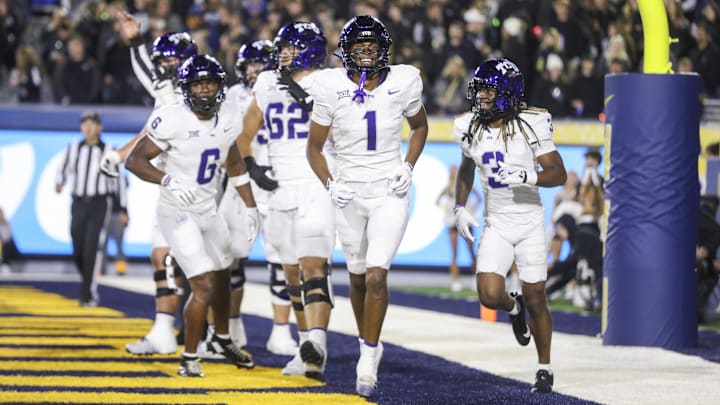 Oct 25, 2025; Morgantown, West Virginia, USA; Texas Christian University Horned Frogs wide receiver Eric McAlister (1) celebrates with teammates after catching a touchdown during the second quarter against the West Virginia Mountaineers at Milan Puskar Stadium. Mandatory Credit: Ben Queen-Imagn Images