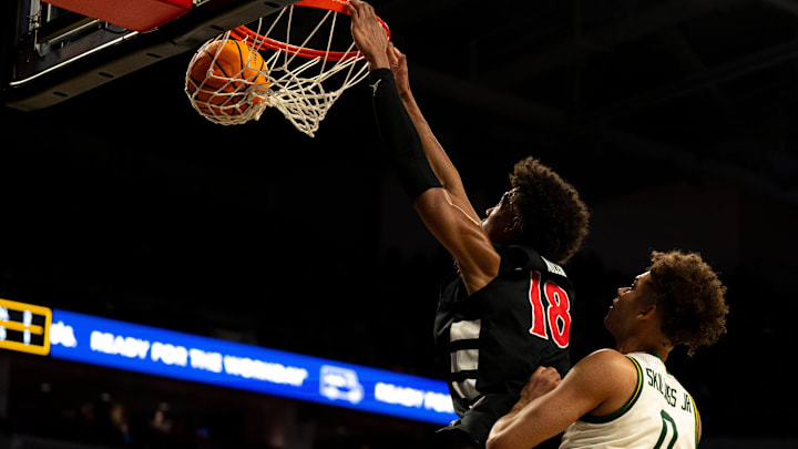 Cincinnati Bearcats forward Baba Miller (18) dunks around Baylor Bears guard Dan Skillings Jr. (0) in the second half of the NCAA basketball game at Fifth Third Arena in Cincinnati on Jan. 28, 2026.