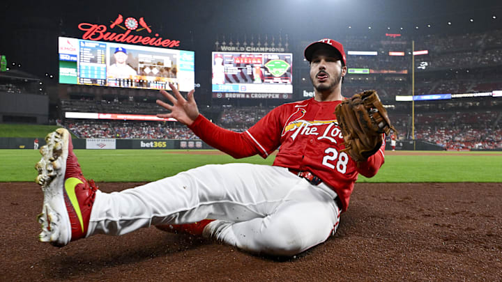 Jun 6, 2025; St. Louis, Missouri, USA;  St. Louis Cardinals third baseman Nolan Arenado (28) slides in to foul territory after catching a foul ball hit by Los Angeles Dodgers left fielder Michael Conforto (not pictured) during the sixth inning at Busch Stadium. Mandatory Credit: Jeff Curry-Imagn Images