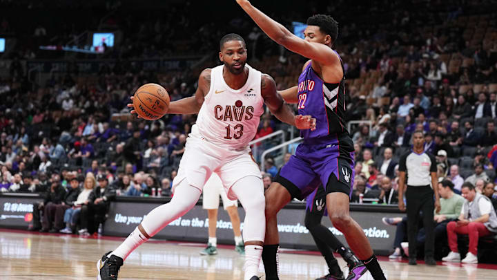 Oct 23, 2024; Toronto, Ontario, CAN; Cleveland Cavaliers center Tristan Thompson (13) controls the ball as Toronto Raptors center Ulrich Chomche (22) tries to defend during the fourth quarter at Scotiabank Arena. Mandatory Credit: Nick Turchiaro-Imagn Images