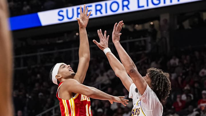 Nov 8, 2025; Atlanta, Georgia, USA; Atlanta Hawks forward Asa Newell (14) shoots against Los Angeles Lakers center Jaxson Hayes (11) during the second half at State Farm Arena.
