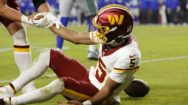 Nov 2, 2025; Landover, Maryland, USA; Washington Commanders quarterback Jayden Daniels (5) is injured on a play during the second half against the Seattle Seahawks at Northwest Stadium. Mandatory Credit: Amber Searls-Imagn Images