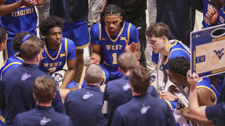 Jan 31, 2026; Morgantown, West Virginia, USA; West Virginia Mountaineers head coach Ross Hodge talks to his players during a timeout during the second half against the Baylor Bears at Hope Coliseum. Mandatory Credit: Ben Queen-Imagn Images Jan 31, 2026; Morgantown, West Virginia, USA; West Virginia Mountaineers head coach Ross Hodge talks to his players during a timeout during the second half against the Baylor Bears at Hope Coliseum. Mandatory Credit: Ben Queen-Imagn Images
