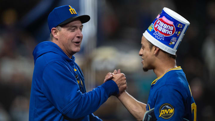 Seattle Mariners manager Dan Wilson (left) and shortstop Leo Rivas celebrate after a win against the San Francisco Giants on Aug. 23 at T-Mobile Park.