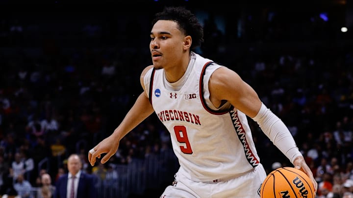 Mar 20, 2025; Denver, CO, USA; Wisconsin Badgers guard John Tonje (9) dribbles the ball against the Montana Grizzlies during the first half in the first round of the NCAA Tournament at Ball Arena.