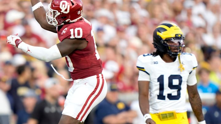 Oklahoma's Kip Lewis (10) celebrates a play in front of Michigan's Bryce Underwood (19) Oklahoma's Kip Lewis (10) celebrates a play in front of Michigan's Bryce Underwood (19)