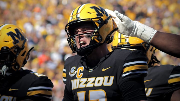 Oct 19, 2024; Columbia, Missouri, USA; Missouri Tigers quarterback Brady Cook (12) celebrates after his team scored a touchdown against the Auburn Tigers at Faurot Field at Memorial Stadium. 
