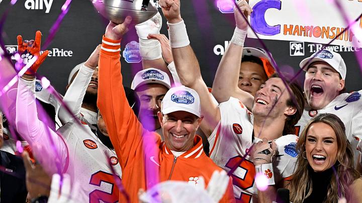 Dec 7, 2024; Charlotte, NC, USA; Clemson Tigers head coach Dabo Swinney, quarterback Cade Klubnik (2) and teammates celebrate after winning the 2024 ACC Championship game against the Southern Methodist Mustangs at Bank of America Stadium. Mandatory Credit: Bob Donnan-Imagn Images