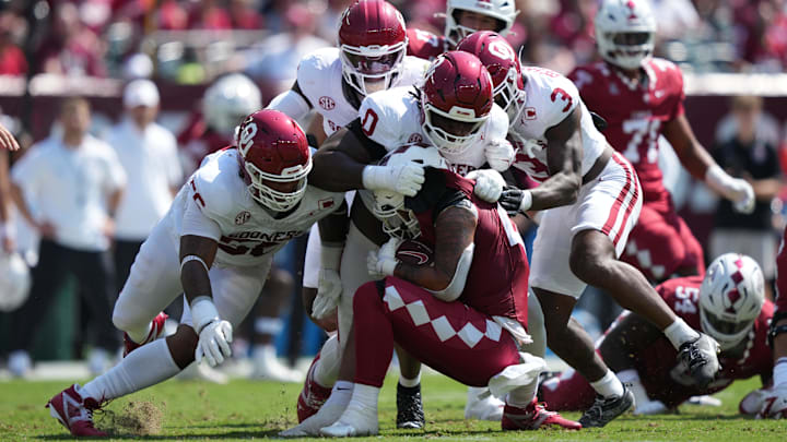 Oklahoma defensive tackle David Stone leads a group of Sooners in a tackle for loss against Temple.