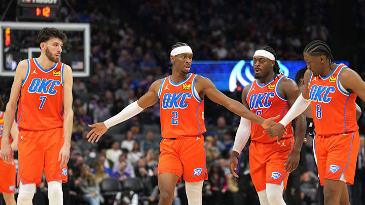 Dec 14, 2023; Sacramento, California, USA; Oklahoma City Thunder guard Shai Gilgeous-Alexander (2) walks to the bench with forwards Chet Holmgren (7) and Jalen Williams (8) and guard Luguentz Dort (second from right) during the fourth quarter against the Sacramento Kings at Golden 1 Center. Mandatory Credit: Darren Yamashita-Imagn Images