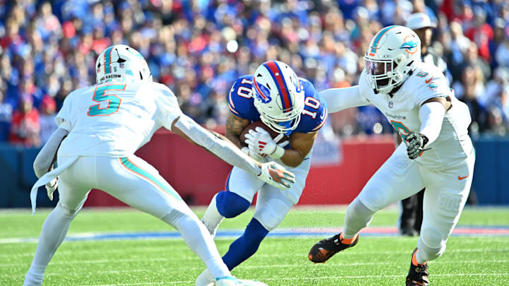 Nov 3, 2024; Orchard Park, New York, USA; Buffalo Bills wide receiver Khalil Shakir (10) ducks to try to avoid a tackle by Miami Dolphins cornerback Jalen Ramsey (5) and linebacker Anthony Walker Jr. (6) in the first quarter at Highmark Stadium. Nov 3, 2024; Orchard Park, New York, USA; Buffalo Bills wide receiver Khalil Shakir (10) ducks to try to avoid a tackle by Miami Dolphins cornerback Jalen Ramsey (5) and linebacker Anthony Walker Jr. (6) in the first quarter at Highmark Stadium.