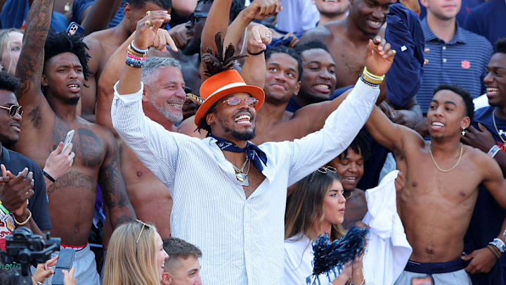 AUBURN, ALABAMA - OCTOBER 09: Former Auburn and NFL quarterback Cam Newton along with head men's basketball coach Bruce Pearl of the Auburn Tigers cheer with the fans prior to the game against the Georgia Bulldogs at Jordan-Hare Stadium on October 09, 2021 in Auburn, Alabama. AUBURN, ALABAMA - OCTOBER 09: Former Auburn and NFL quarterback Cam Newton along with head men's basketball coach Bruce Pearl of the Auburn Tigers cheer with the fans prior to the game against the Georgia Bulldogs at Jordan-Hare Stadium on October 09, 2021 in Auburn, Alabama.