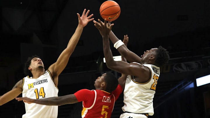 Nov 9, 2025; Columbia, Missouri, USA; Missouri Tigers senior forwards Mark Mitchell (25) and Jevon Porter (14) go up for the ball against VMI junior guard AJ Clark (5) during a matchup against the Keydets at Mizzou Arena. Nov 9, 2025; Columbia, Missouri, USA; Missouri Tigers senior forwards Mark Mitchell (25) and Jevon Porter (14) go up for the ball against VMI junior guard AJ Clark (5) during a matchup against the Keydets at Mizzou Arena.