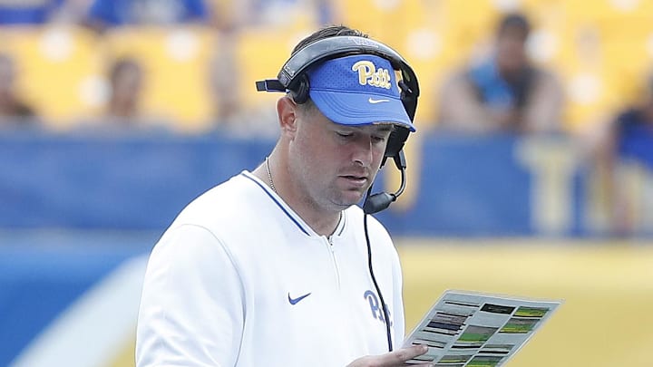 Aug 31, 2024; Pittsburgh, Pennsylvania, USA;  Pittsburgh Panthers offensive coordinator Kade Bell looks at his play chart against the Kent State Golden Flashes during the fourth quarter at Acrisure Stadium. Mandatory Credit: Charles LeClaire-Imagn Images