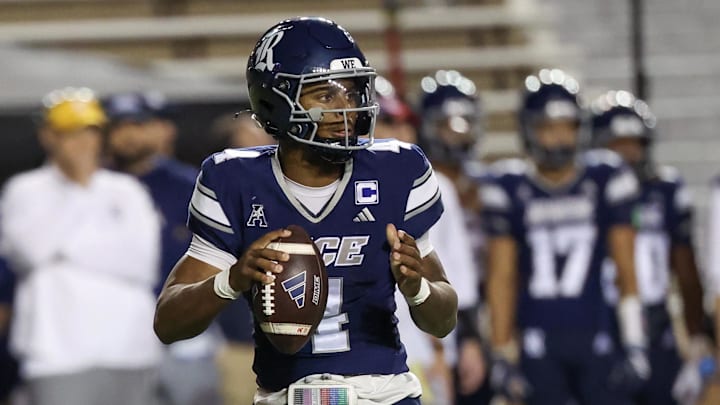 Oct 31, 2025; Houston, Texas, USA;  Rice Owls quarterback Chase Jenkins (4) in the pocket against the Memphis Tigers in the second half at Rice Stadium. Mandatory Credit: Thomas Shea-Imagn Images