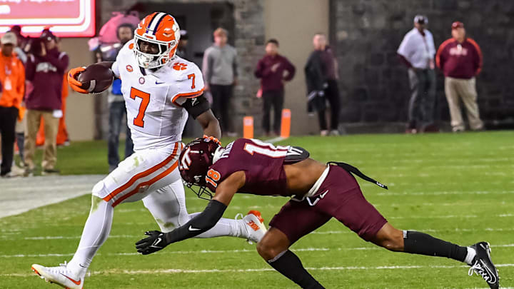 Nov 9, 2024; Blacksburg, Virginia, USA;  Virginia Tech Hokies safety Mose Phillips III (18) dives to tackle Clemson Tigers running back Phil Mafah (7) as he runs the ball during the third quarter at Lane Stadium. 