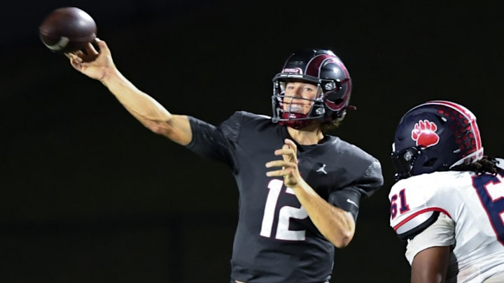 Westside High senior quarterback Cutter Woods (12) passes near Belton-Honea Path High junior Kylan Dixon (61) during the second quarter at Westside High in Anderson, S.C. Friday, September 13, 2024.