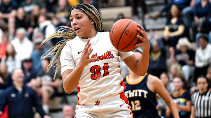 Belleville's Sydney Savoury grabs a rebound against DeWitt during the third quarter on Tuesday, March 18, 2025, in the D1 state quarterfinal at Holt High School.