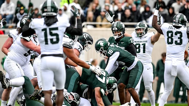 Michigan State's offense celebrates as Jalen Berger scores on a run during the Spring Showcase on Saturday, April 20, 2024, at Spartan Stadium in East Lansing.