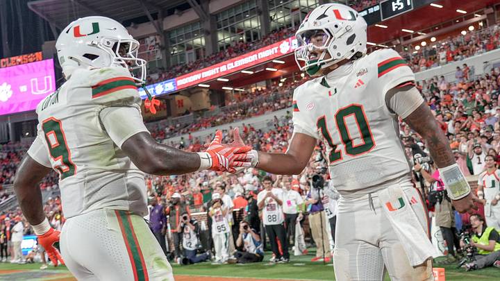 Miami Hurricanes quarterback Darian Mensah (10), right, scores and celebrates with teammate Miami Hurricanes tight end Elija Lofton (9) playing Clemson during the third quarter at Memorial Stadium Saturday, October 3, 2026.
