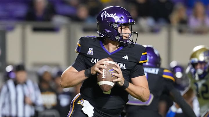 Oct 16, 2025; Greenville, North Carolina, USA; East Carolina Pirates quarterback Katin Houser (4) rolls out of the pocket against the Tulsa Golden Hurricane during the first half at Dowdy-Ficklen Stadium. Mandatory Credit: James Guillory-Imagn Images Oct 16, 2025; Greenville, North Carolina, USA; East Carolina Pirates quarterback Katin Houser (4) rolls out of the pocket against the Tulsa Golden Hurricane during the first half at Dowdy-Ficklen Stadium. Mandatory Credit: James Guillory-Imagn Images