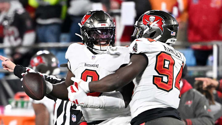 Tampa Bay Buccaneers linebacker Yaya Diaby celebrates with defensive tackle Calijah Kancey.