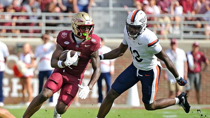 Oct 3, 2026; Tallahassee, Florida, USA;  Florida State Seminoles running back Quintrevion Wisner (5) runs the ball past Virginia Cavaliers linebacker Myles Brown (13) during the second half at Doak S. Campbell Stadium.  Mandatory Credit: Melina Myers-Imagn Images