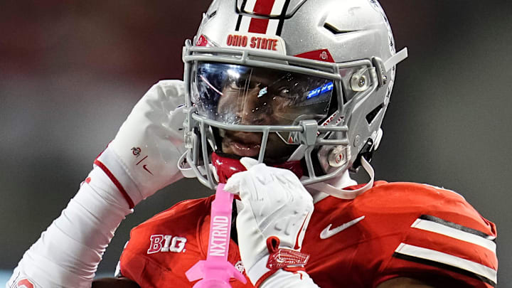 Ohio State Buckeyes defensive back Caleb Downs (2) buttons his chin strap during the first half of the NCAA football game against the Minnesota Golden Gophers at Ohio Stadium in Columbus on Oct. 4, 2025.