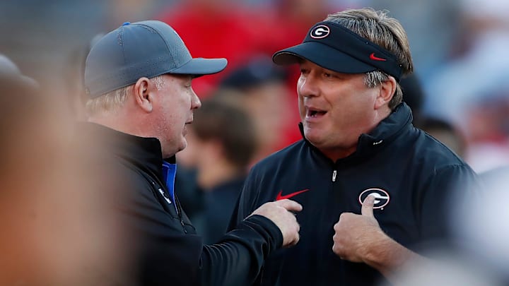 Georgia coach Kirby Smart speaks with Kentucky coach Mark Stoops before the start of a NCAA college football game against Kentucky in Athens, Ga., on Saturday, Oct. 7, 2023.