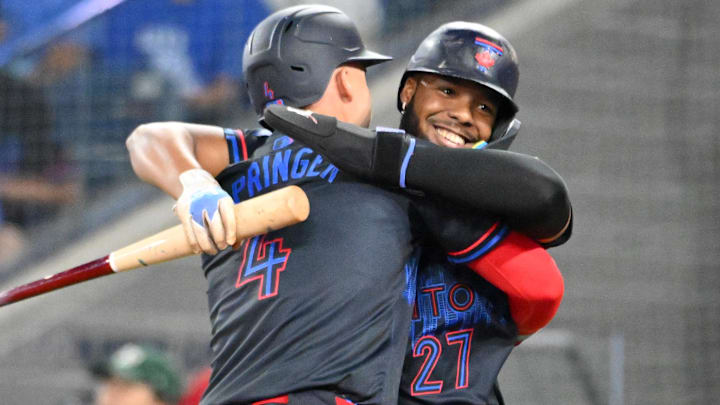 May 30, 2025; Toronto, Ontario, CAN;  Toronto Blue Jays first baseman Vladimir Guerrero Jr. (27) greets designated hitter George Springer (4) after they both scored runs against the Athletics in the fifth inning at Rogers Centre