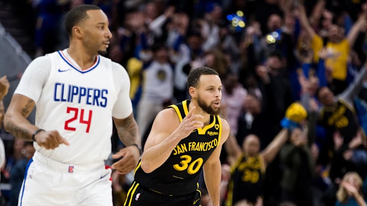 Golden State Warriors guard Stephen Curry (30) gestures next to LA Clippers guard Norman Powell (24) during the second half at Chase Center. Mandatory Credit: John Hefti-Imagn Images
