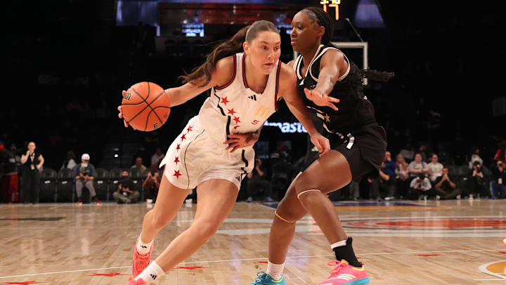 Apr 1, 2025; Brooklyn, NY, USA; McDonald's All American West guard Emilee Skinner (5) drives to the basket against McDonald's All American East guard Hailee Swain (2) during the first half of the game at Barclays Center. Mandatory Credit: Pamela Smith-Imagn Images