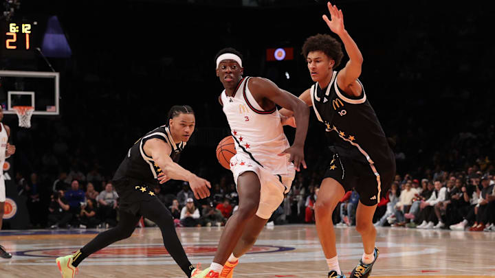 McDonald's All American West forward and BYU signee AJ Dybantsa (3) drives to the basket against McDonald's All American East guard Isiah Harwell (0) and McDonald's All American East forward Nate Ament (10). Harwell has signed with Houston.