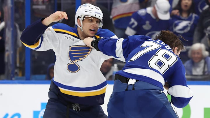 Dec 19, 2024; Tampa, Florida, USA; St. Louis Blues center Brayden Schenn (10) and Tampa Bay Lightning defenseman Emil Lilleberg (78) fight during the second period at Amalie Arena. Mandatory Credit: Kim Klement Neitzel-Imagn Images