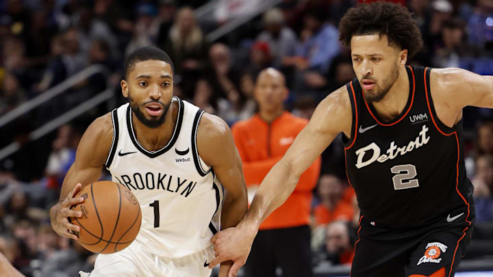 Dec 26, 2023; Detroit, Michigan, USA; Brooklyn Nets forward Mikal Bridges (1) dribbles while Cade Cunningham of the Detroit Pistons defends.