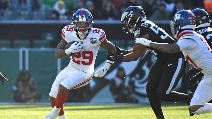 Jan 5, 2025; Philadelphia, Pennsylvania, USA;  New York Giants running back Tyrone Tracy Jr. (29) runs past Philadelphia Eagles linebacker Jeremiah Trotter Jr. (54) during the second quarter at Lincoln Financial Field.  