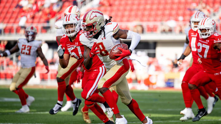 Mar 30, 2025; Washington, D.C., USA; Birmingham Stallions wide receiver Deon Cain (8) runs the ball as DC Defenders linebacker Anthony Hines III (57) defends in the second half at Audi Field. Mandatory Credit: Emily Faith Morgan-Imagn Images