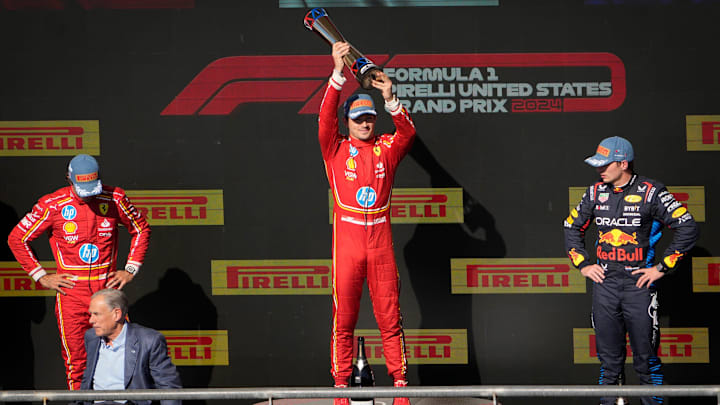 Scuderia Ferrari driver Charles Leclerc of Team Monaco celebrates his win at the Formula 1 Pirelli United States Grand Prix at Circuit of the Americas Sunday October 20, 2024. Scuderia Ferrari driver Carlos Sainz of Team Spain, left, placed second. Oracle Red Bull Racing driver Max Verstappen of Team Netherlands, right, finished third.